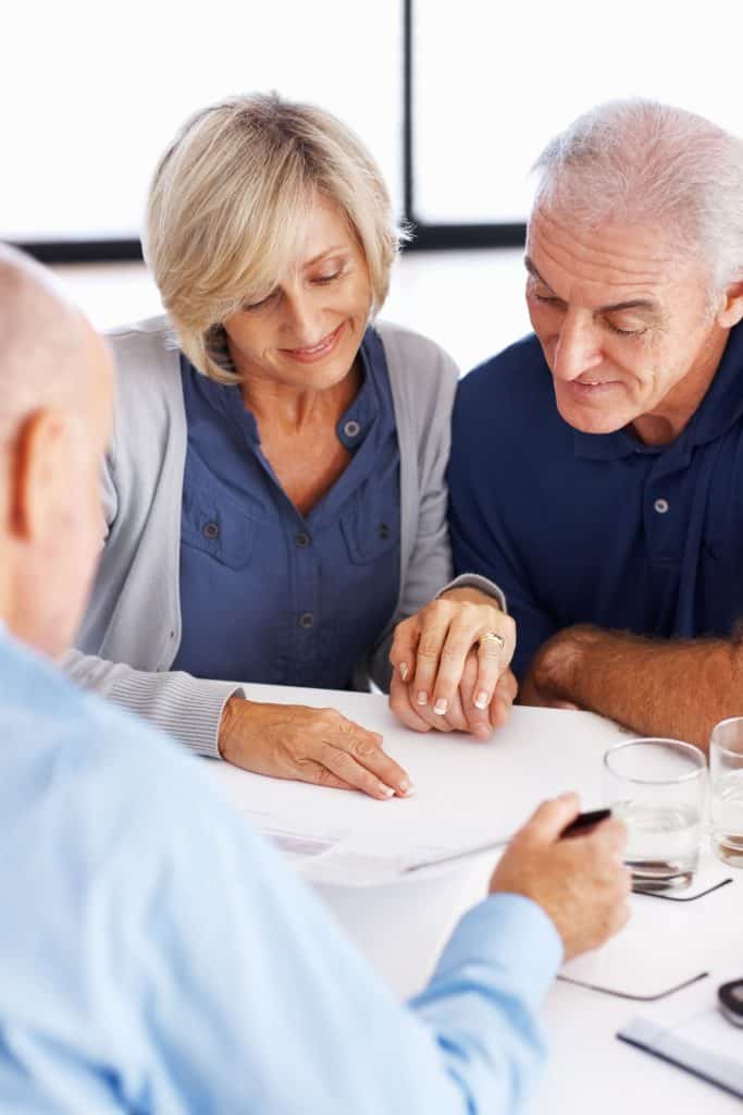 Financial advisor explaining investment plans to senior couple