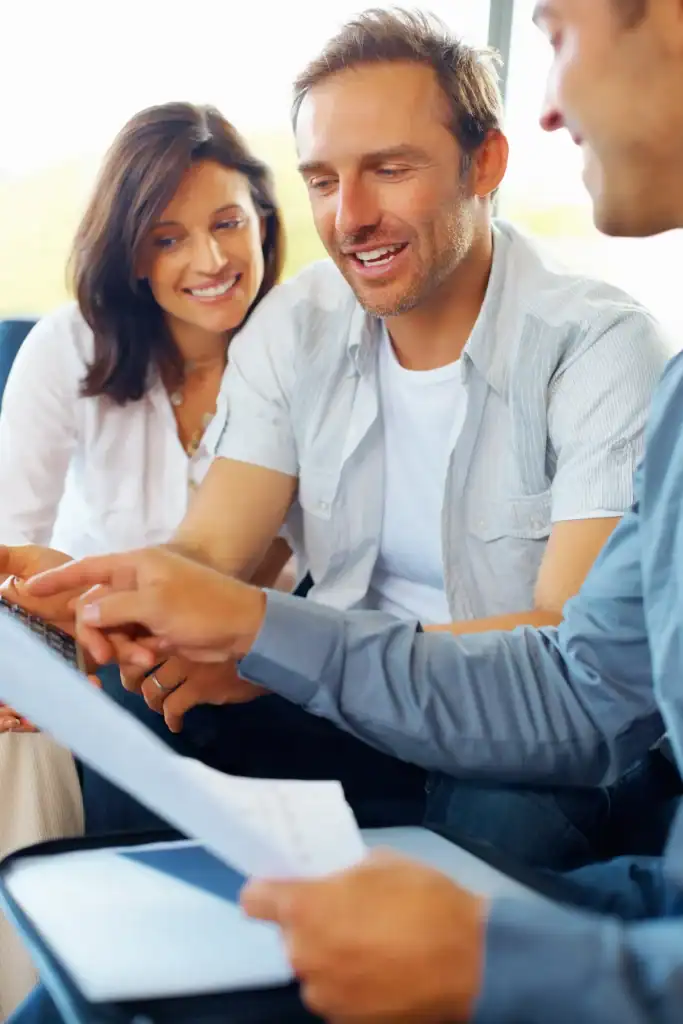 Happy mature couple discussing financial matter with advisor